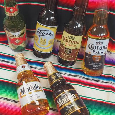 Bottles of Mexican beer placed on a Mexican sarape poncho.