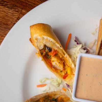 Sliced Southwest egg rolls served with remoulade sauce.