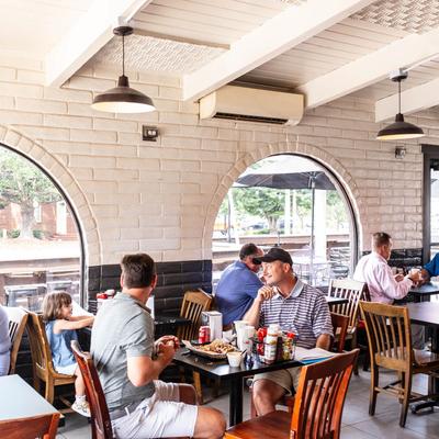 Restaurant interior, people dining at tables.