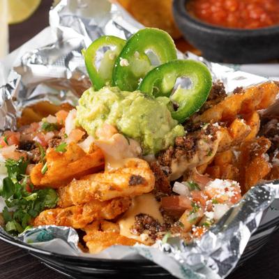 Pequeno Fries with guacamole and jalapeno on top