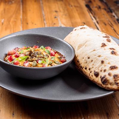 Pumpkin Hummus served with flatbread closeup.