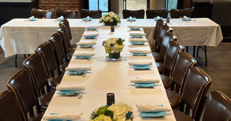 Interior, a table set for four with decorative vase filled with corks