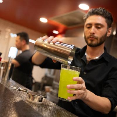 A person mixing a drink.