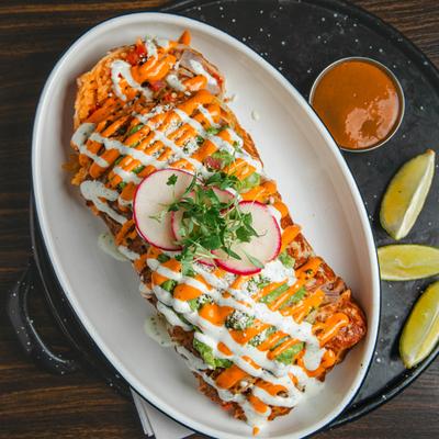 Surf and Turf Burrito, with steak, shrimp, rice, beans, pico de gallo, and a cheesy crust.