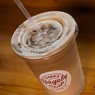 Iced coffee served in a plastic cup with a straw.