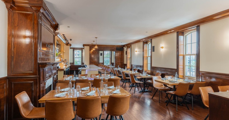 Interior, dining area, wooden top tables with leather padded chairs, wooden flooring