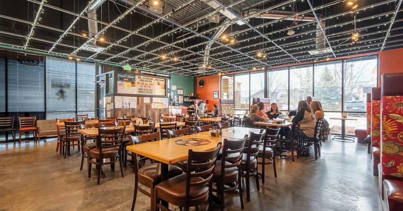 Restaurant interior, dining area, guests chatting and enjoying their food and drinks