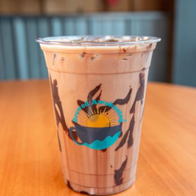 Iced mocha in clear cup with chocolate drizzle.