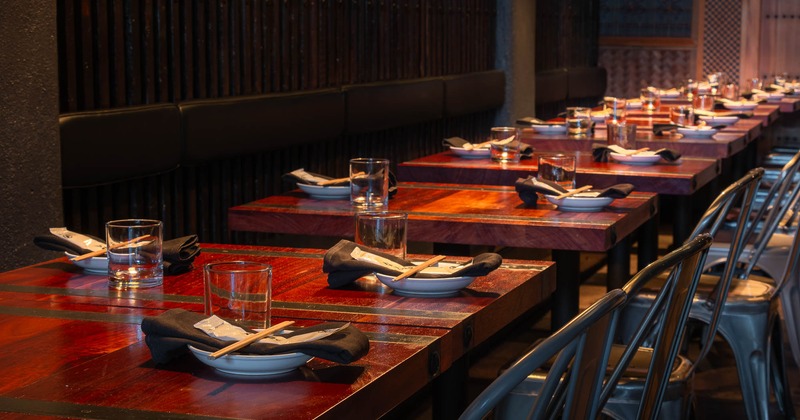Interior, closeup of lined up tables with tableware