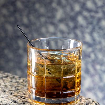 Rocks glass with whiskey.