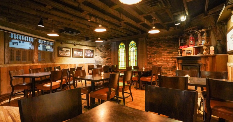 Interior, dining area, tables for eight and four, exposed wooden beams on the ceiling