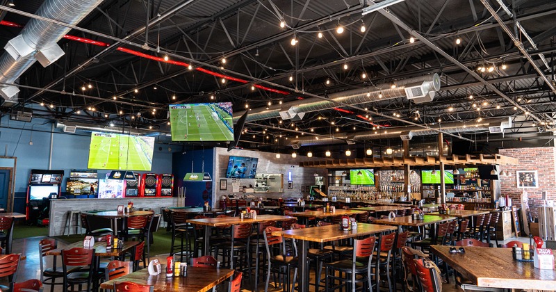 Interior of spacious sports bar, seating and dining area