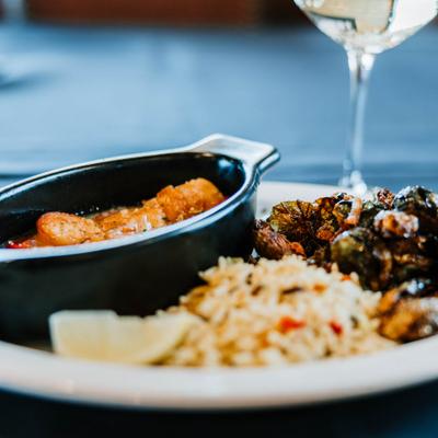 Baked scallops accompanied by roasted Brussels sprouts and rice.