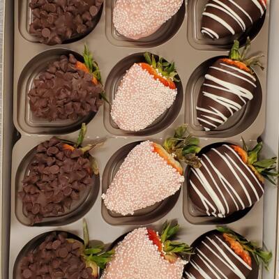 A box of nine chocolate-covered strawberries.