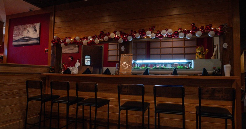 Interior, wooden sushi bar with chairs