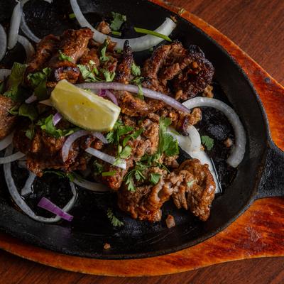 Beef Bihari Kebab, with onions, lime, herbs, and spices.