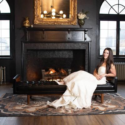 The bride posing in front of the fireplace.