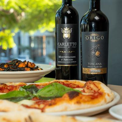 Served pizzas and wine bottles.