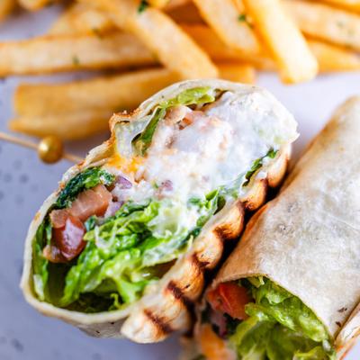 Caesar wrap served alongside fries.