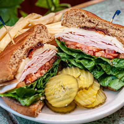 Two sandwiches, vegetables on the side.