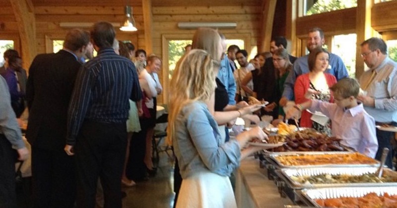 Inside, people helping themselves to food on the table