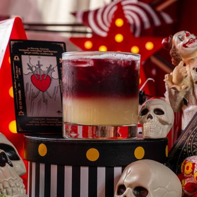 Muerta Lenta cocktail served in a rocks glass, layered with red wine.