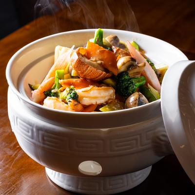 Seafood served in a clay pot.