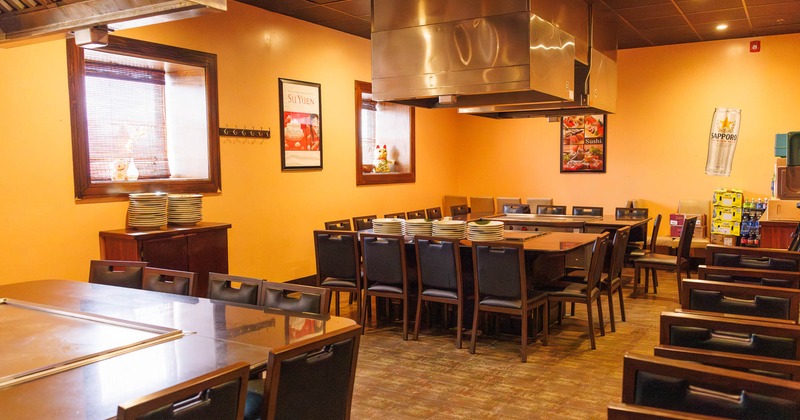 Interior, dining area, hibachi tables with wooden chairs, framed posters as a decoration