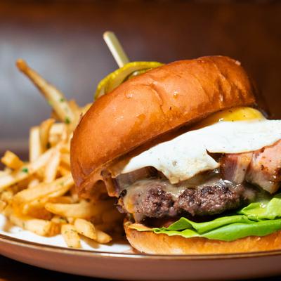 Pork belly burger, with fried egg, and fries.