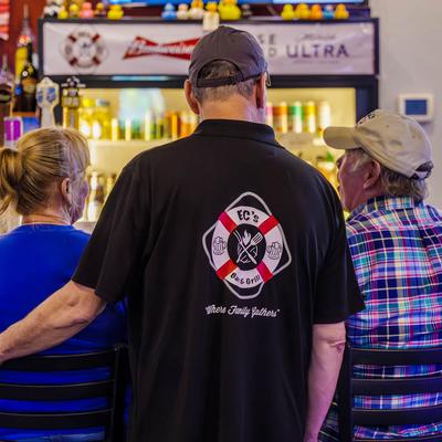 Owner with guests at the bar counter.