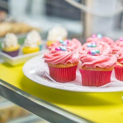 Pink cupcakes topped with colorful candy beads.