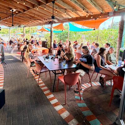 People dining beneath a covered outdoor patio.