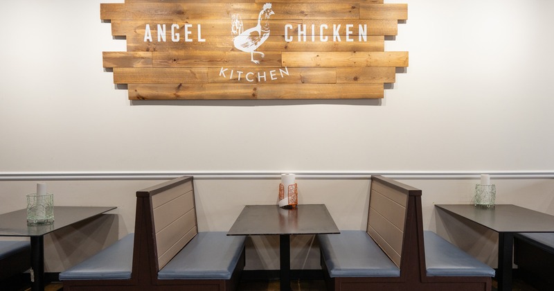 Dining booths lined up along the wall, restaurant logo on the wall
