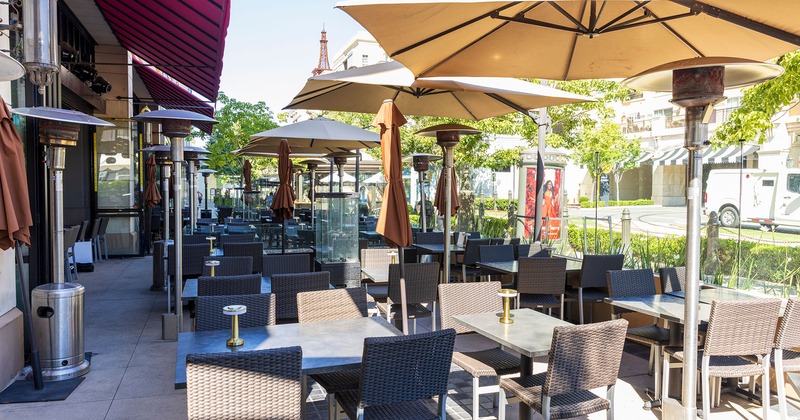 Patio, seating area with sunshade umbrellas and heaters