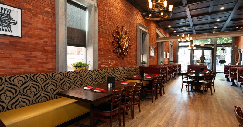 Inside, with brick walls, wooden floor, and modern chandeliers