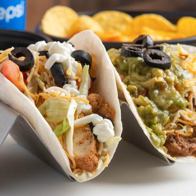 Grilled chicken and ground beef tacos, with toppings.