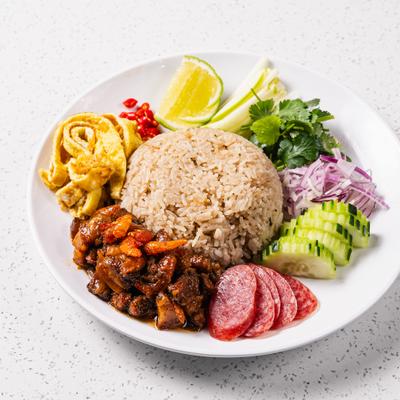 Thai dish featuring fried rice seasoned with shrimp paste, sweetened pork belly and condiments.