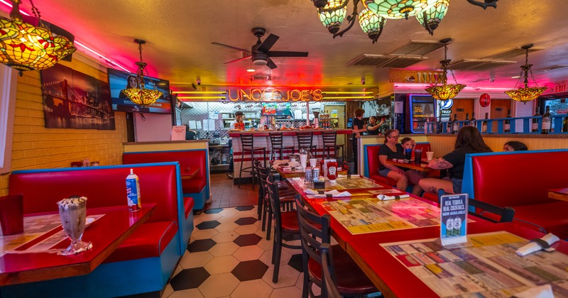 Interior, wide view, booths and table with chairs