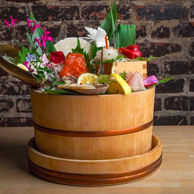 Twenty-piece sashimi meal in a wooden container.