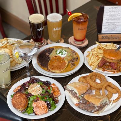 Plates of Tri Tip Sandwich, Salmon Salad , Brewhouse Enchiladas Beers and Cocktails.