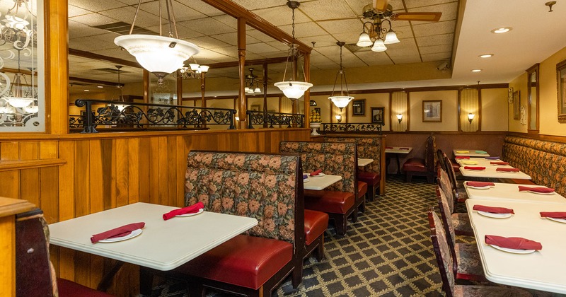 Dining area, booths on the left side and tables with chairs on the right
