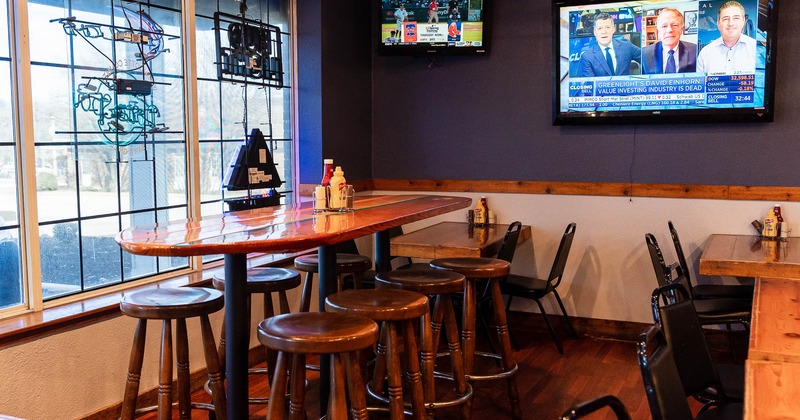 Interior, high seating table and chairs by the windows