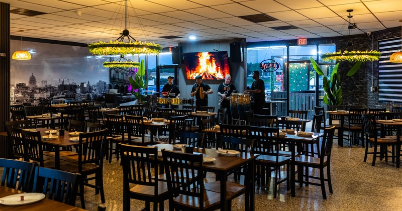 Interior, tables and chairs ready for guests while the band is playing