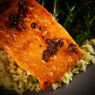 Cedar Salmon served over a bed of pilaf, close-up.