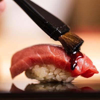 Brushing tuna nigiri sushi.