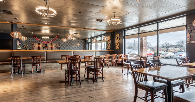 Interior, dining tables and banquette seating by walls