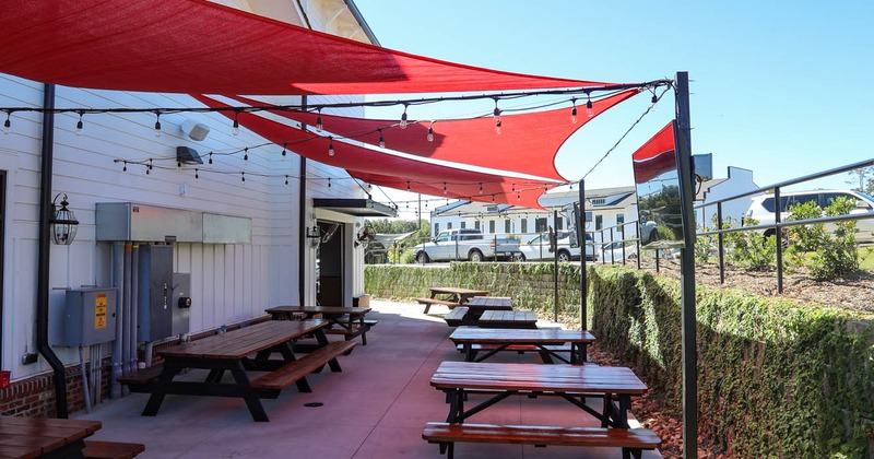 Exterior, conjoined tables and benches in the outdoor seating area