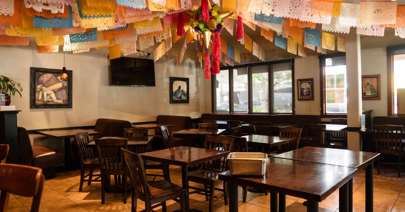 Interior, wide view of dining area, tables and chairs