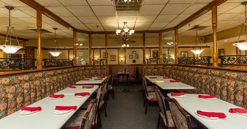 Partitioned dining area with banquette seating, chairs and tables