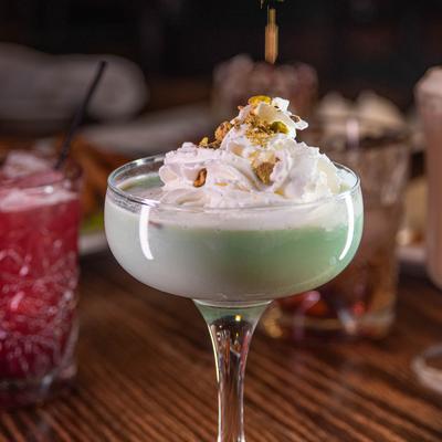 Pistachio Martini topped with whipped cream and crushed pistachios.